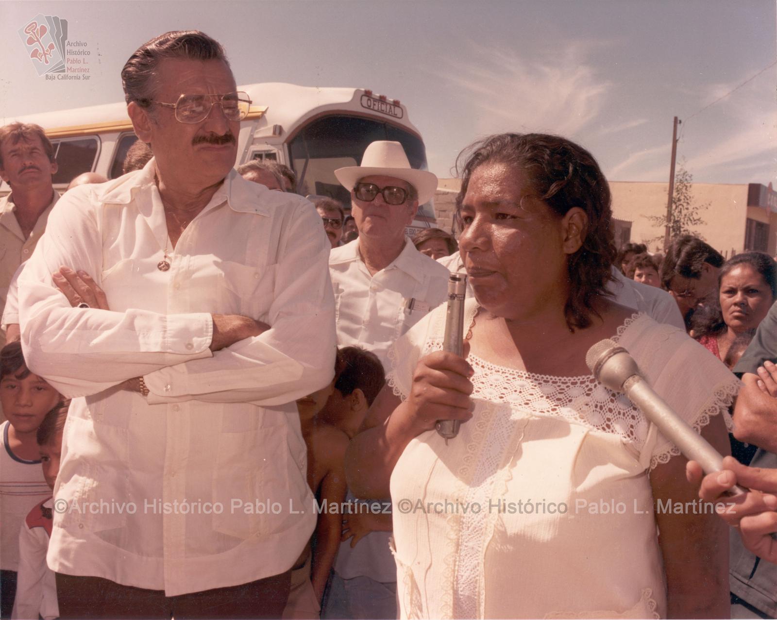 Alberto Andrés Alvarado Arámburo escuchando a una mujer ante micrófono.