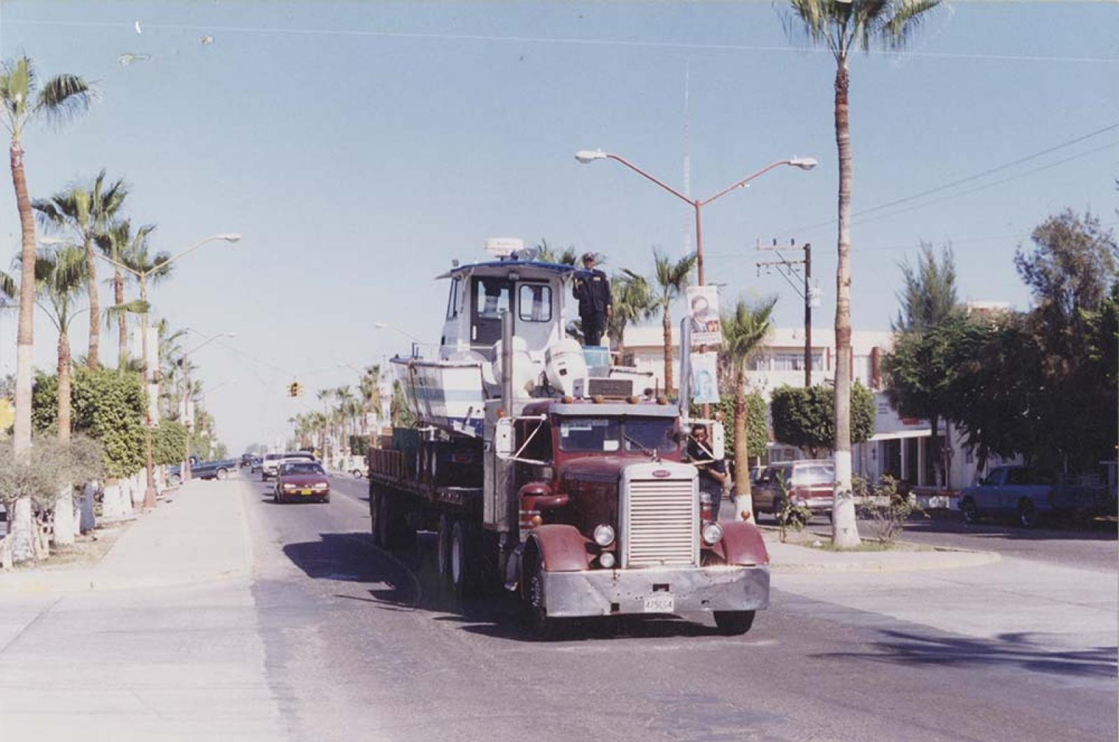 Camión de carga transporta lancha, por la avenida Álvaro Obregón.
