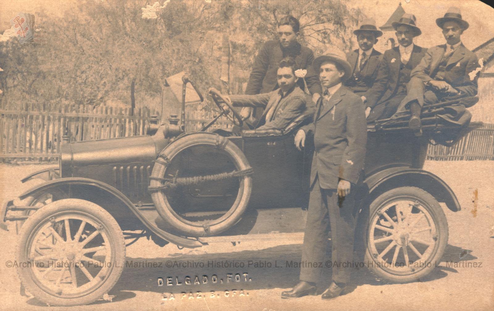 Hombres en automóvil de modelo antiguo.