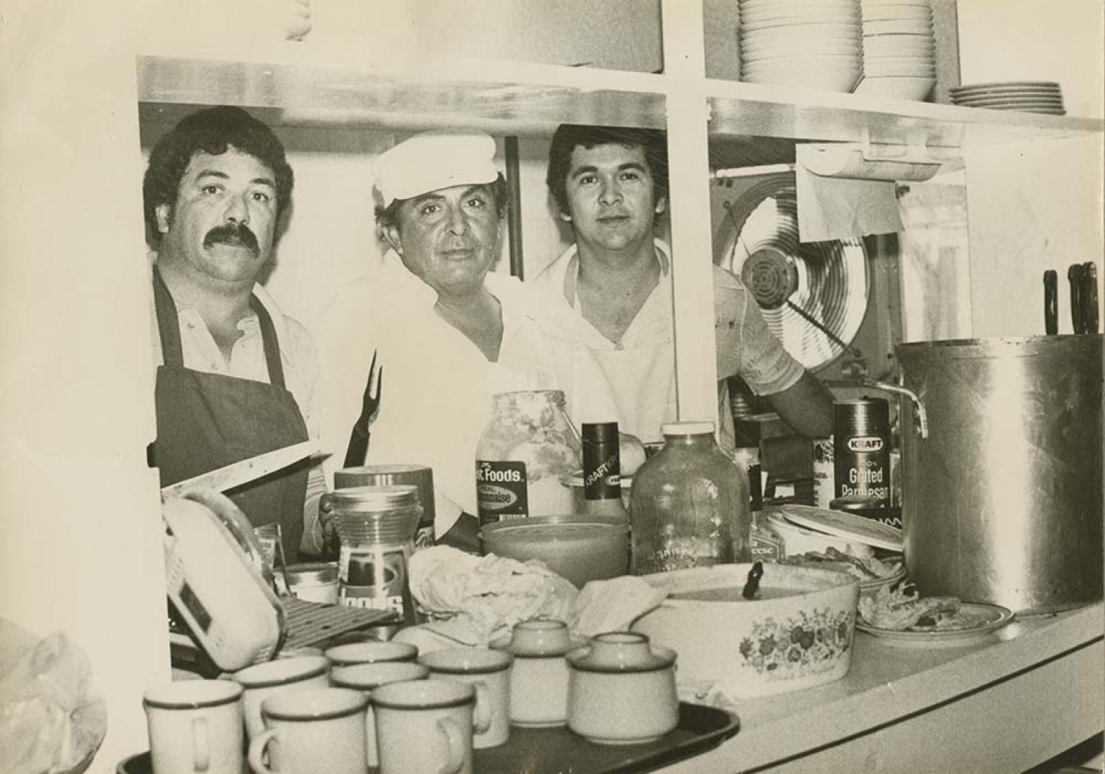 Hombres en interior de cocina.