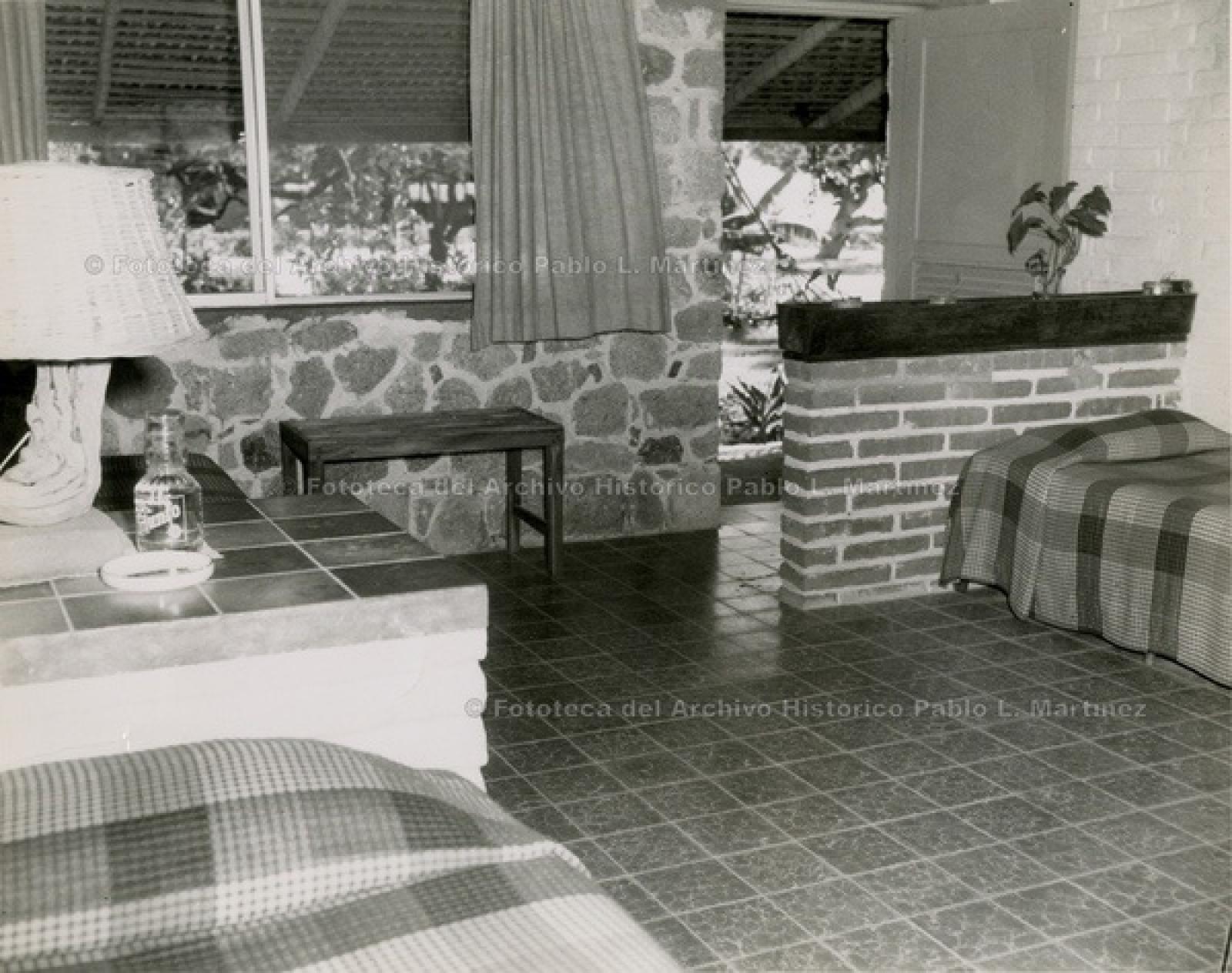 Interior de habitación, con vista hacia jardín.