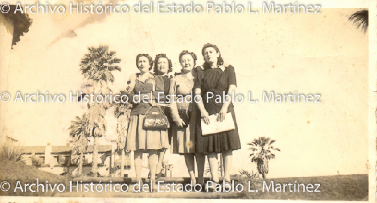 Mujeres frente a palmeras.