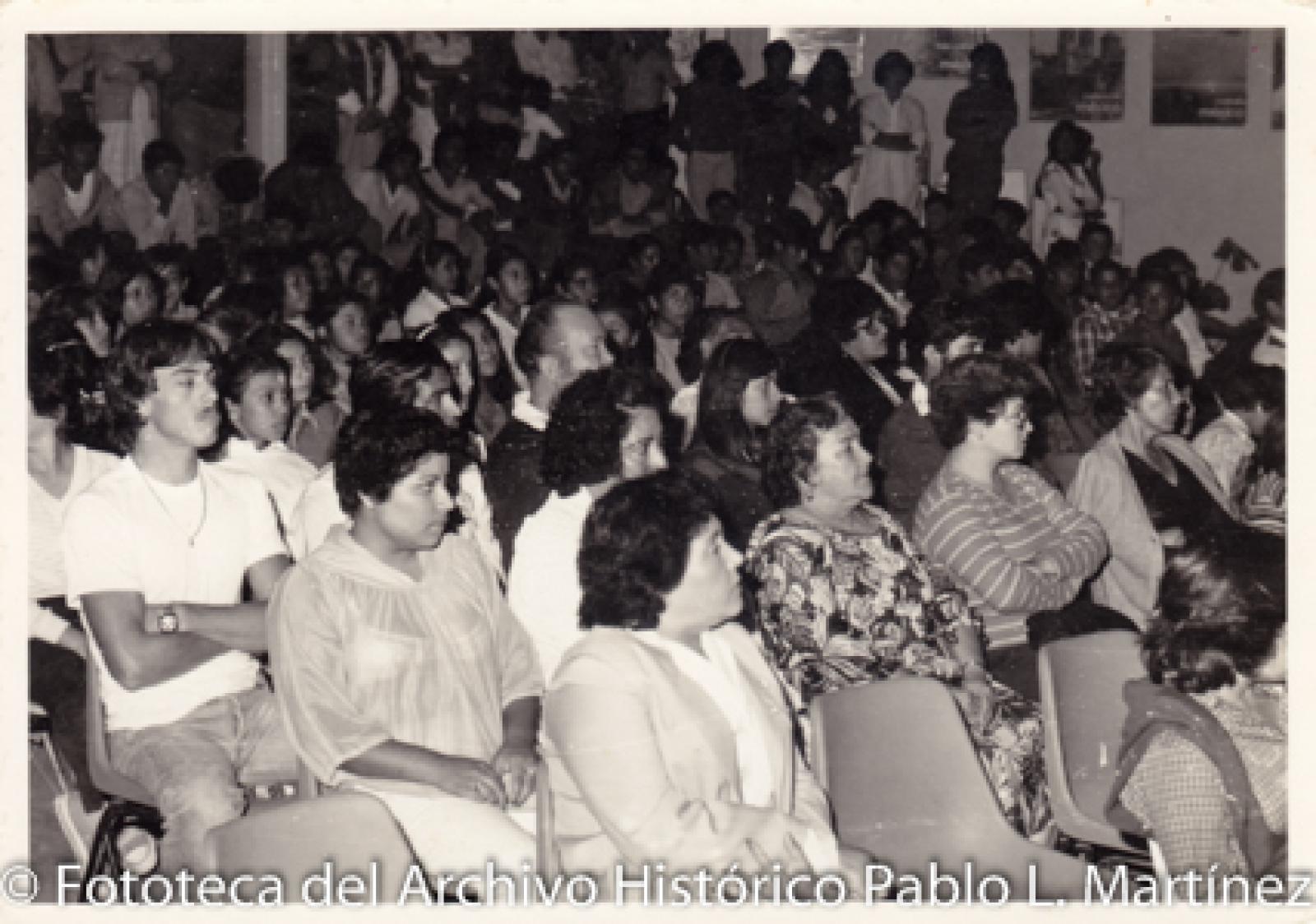Retrato de grupo sentados en interior de auditorio